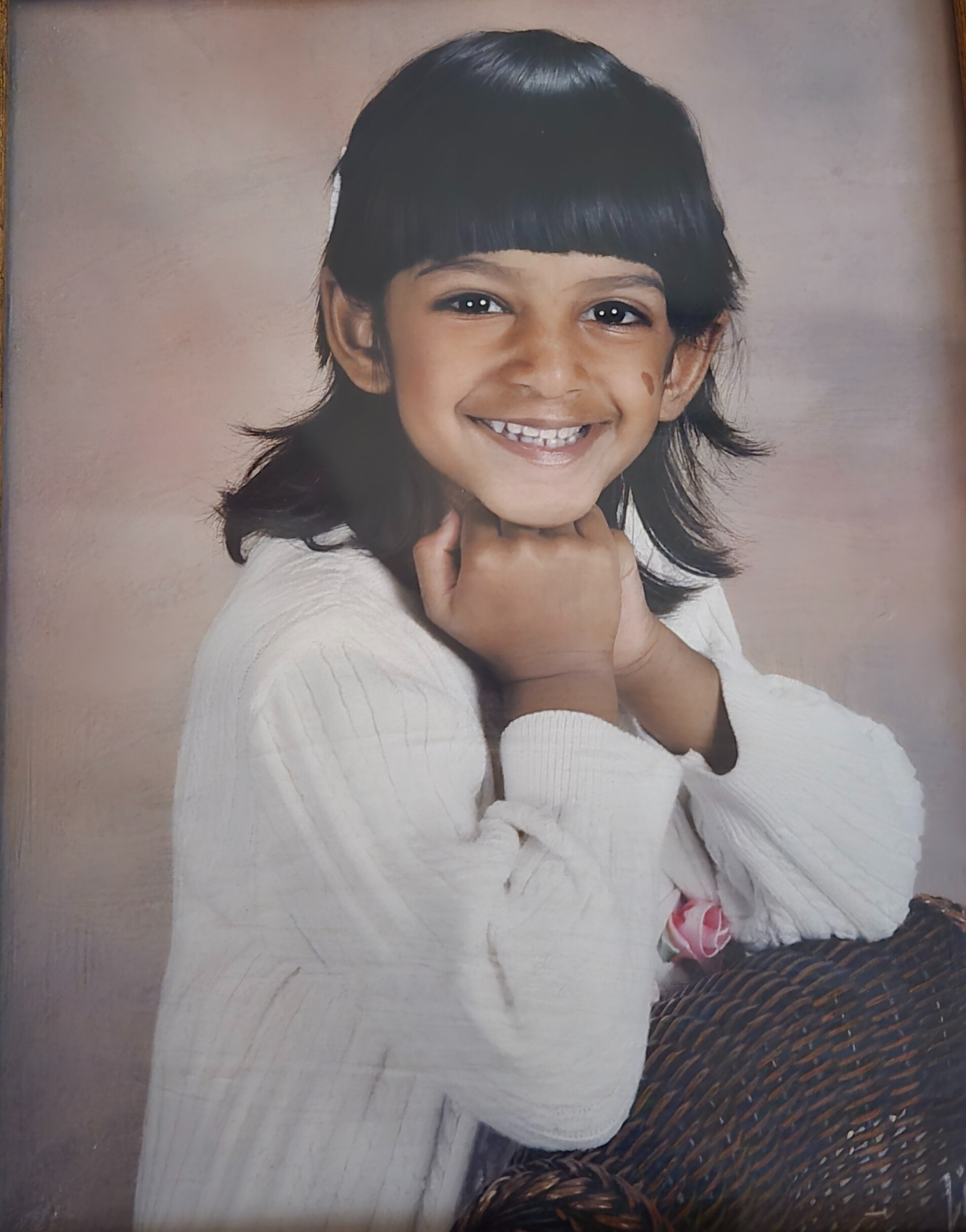 Emmalee, a young Indian girl with long black hair, smiling for a portrait.